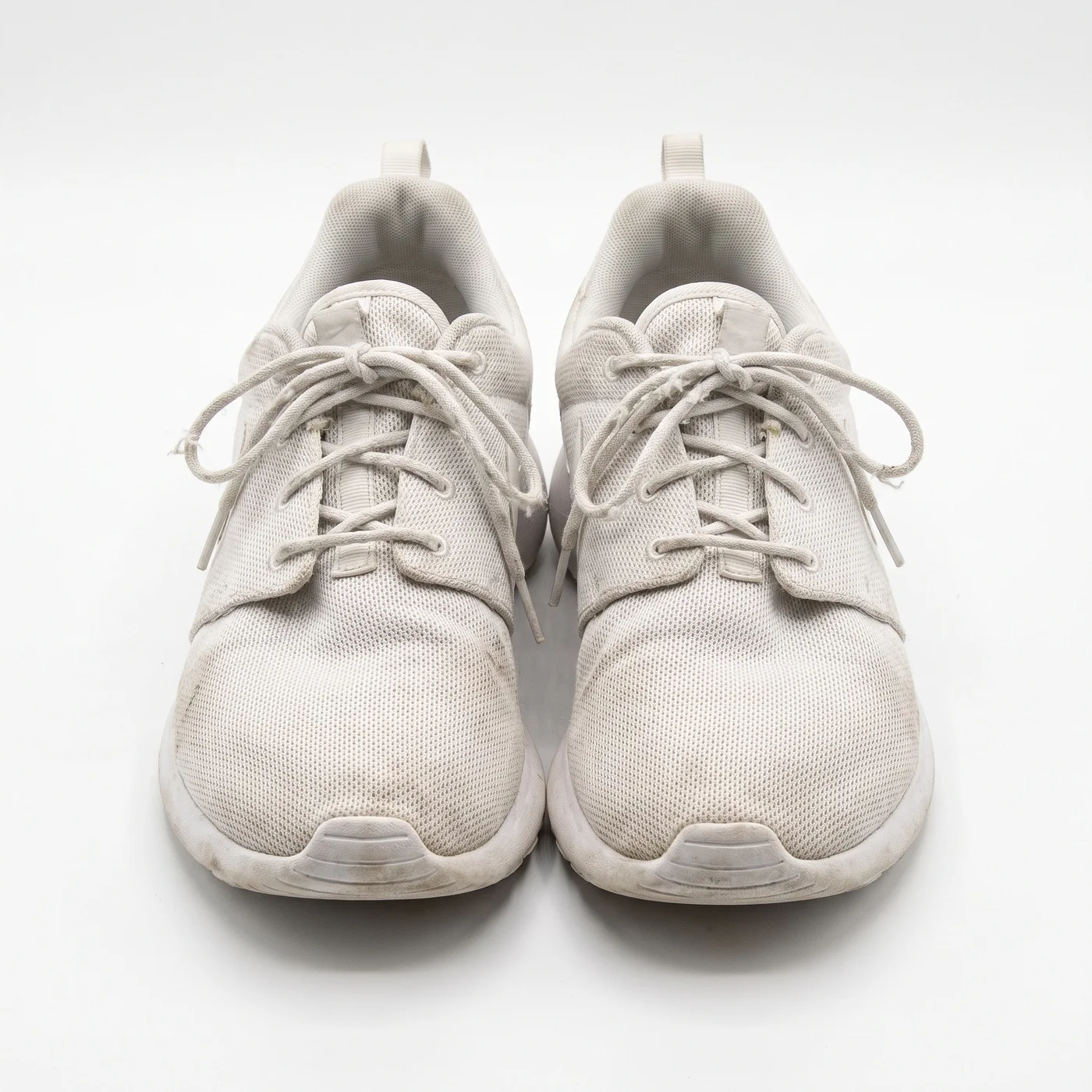 The same white running sneakers centred on a pure white background, cleanly cut out, lace and sole detail sharp, listing-ready